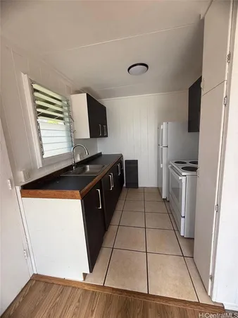 a kitchen with stainless steel appliances a refrigerator sink and microwave
