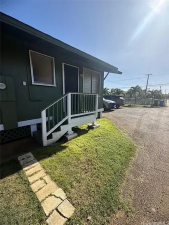 a view of a house with backyard and wooden fence