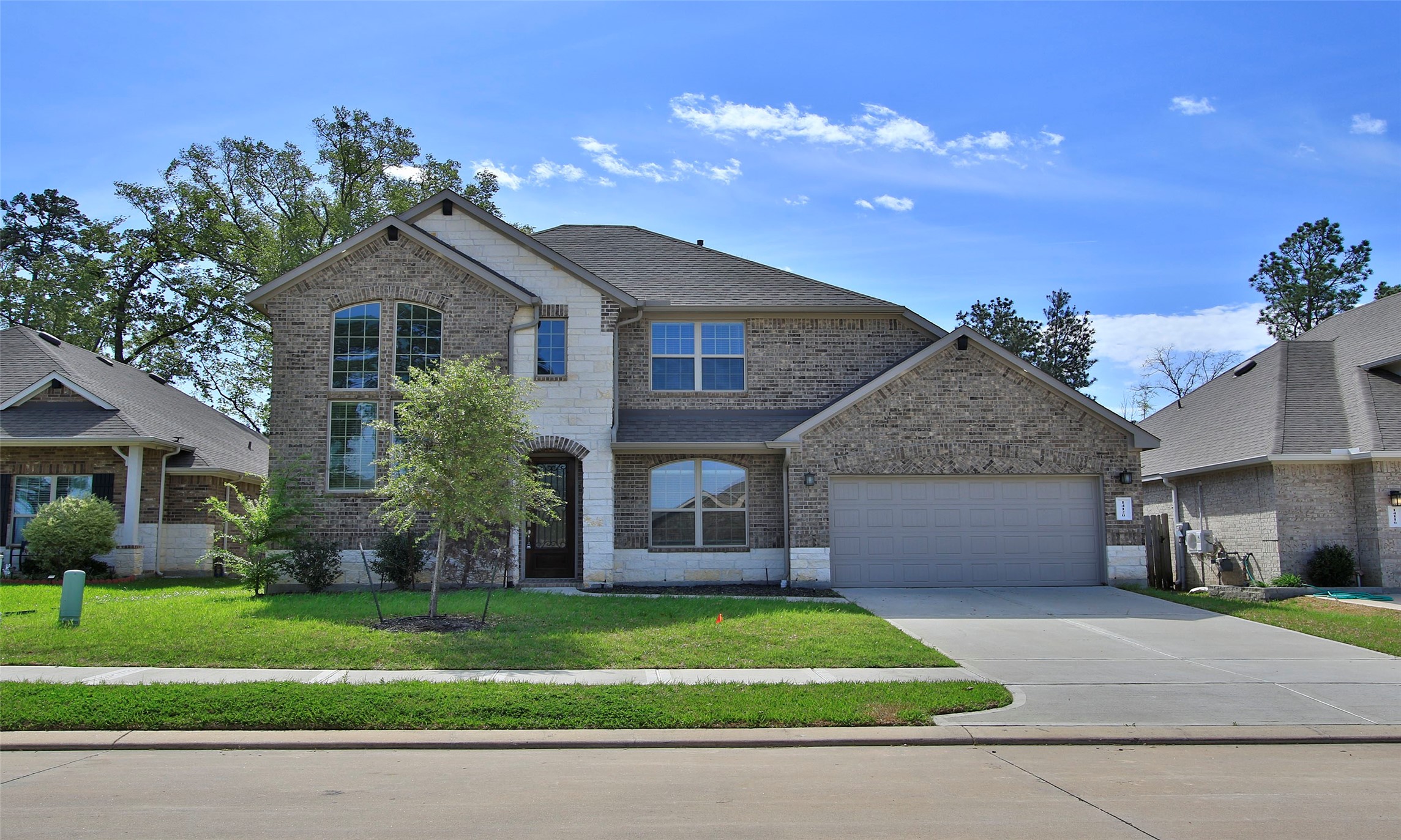 a front view of a house with a garden