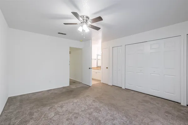 a view of an empty room with a fan