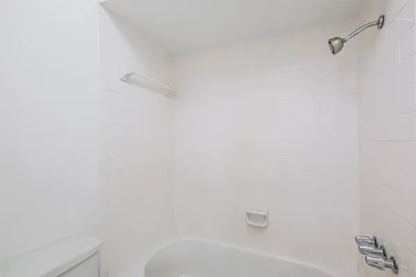 a bathroom with a white bathtub