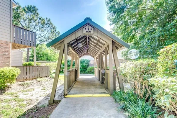 a view of a pathway of a house with wooden floor and fence