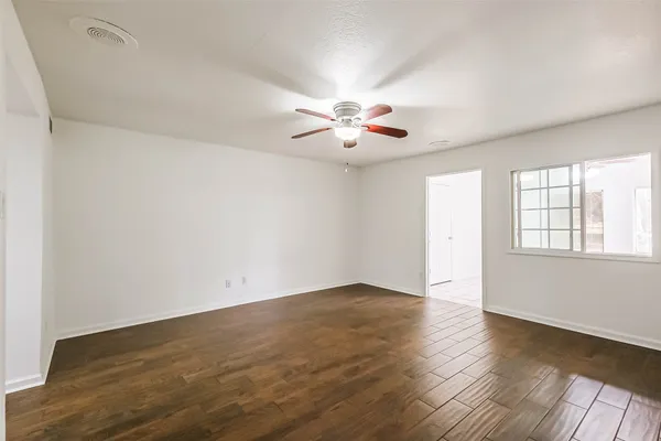 wooden floor in an empty room with a window