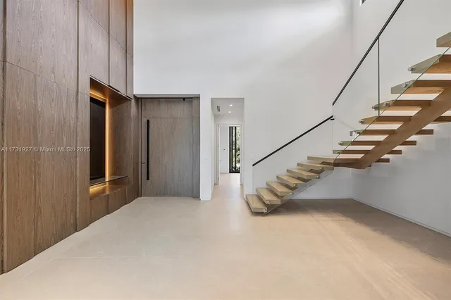 a view of an empty room with windows and a balcony