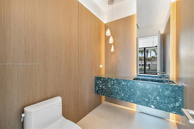 a bathroom with a green shower and a mirror