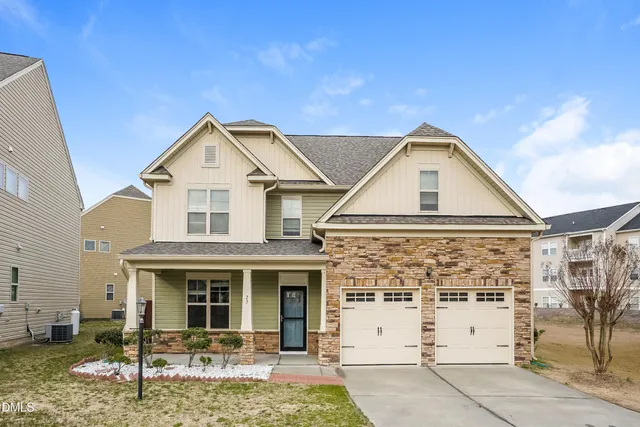 a view of a white house with large windows and a yard