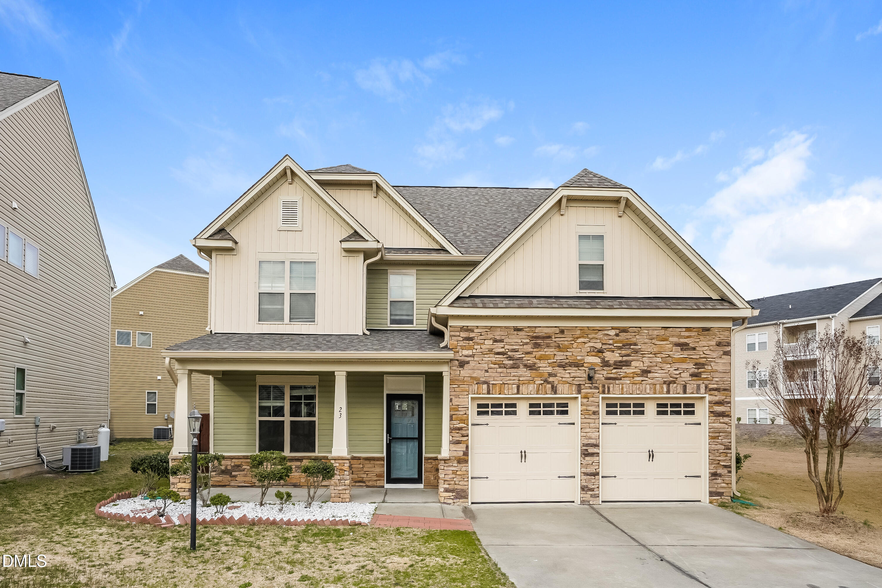 a view of a white house with large windows and a yard