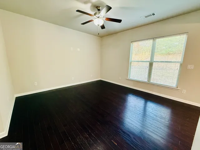 a view of a bathroom with wooden floor and a toilet