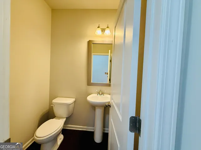 a view of hallway with stairs and wooden floor