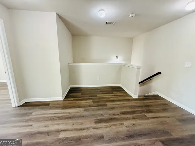 a front view of a house with a yard and fountain