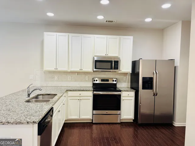 a kitchen with a sink microwave and refrigerator