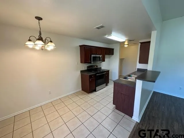 a kitchen with stainless steel appliances a sink stove and refrigerator