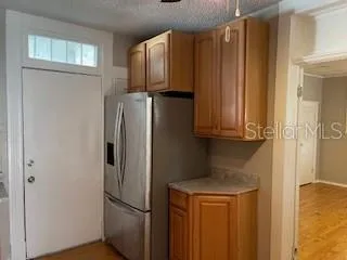 a metallic refrigerator freezer sitting in a kitchen
