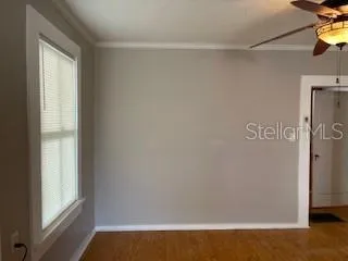 a view of small space with wooden floor and a window