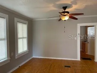 wooden floor in an empty room with a window