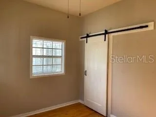 a view of a room with a window and a ceiling fan