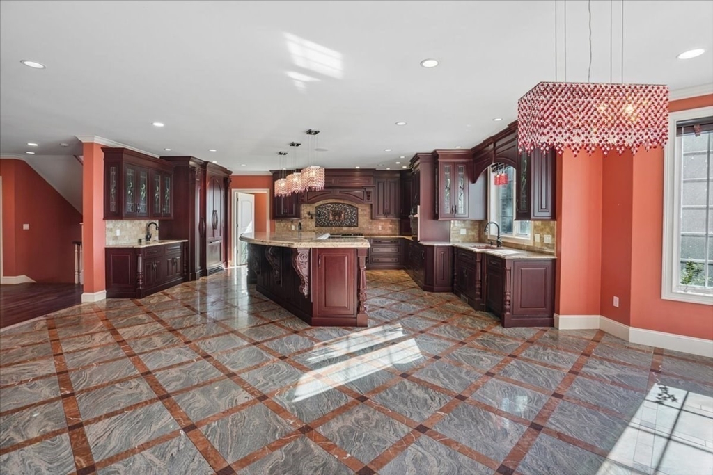 3 Regency Ridge Andover, MA 01810 - Photo 11 of 40 a kitchen with stainless steel appliances granite countertop a sink stove and cabinets