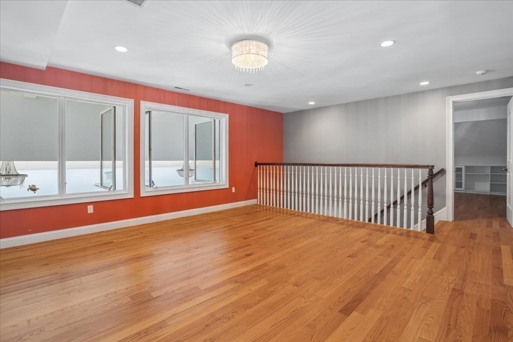 3 Regency Ridge Andover, MA 01810 - Photo 18 of 40 a view of an empty room with wooden floor and windows