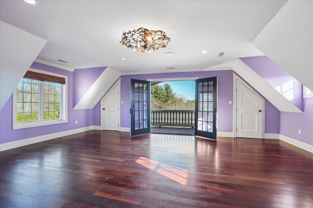 3 Regency Ridge Andover, MA 01810 - Photo 22 of 40 a view of an empty room with wooden floor and a window