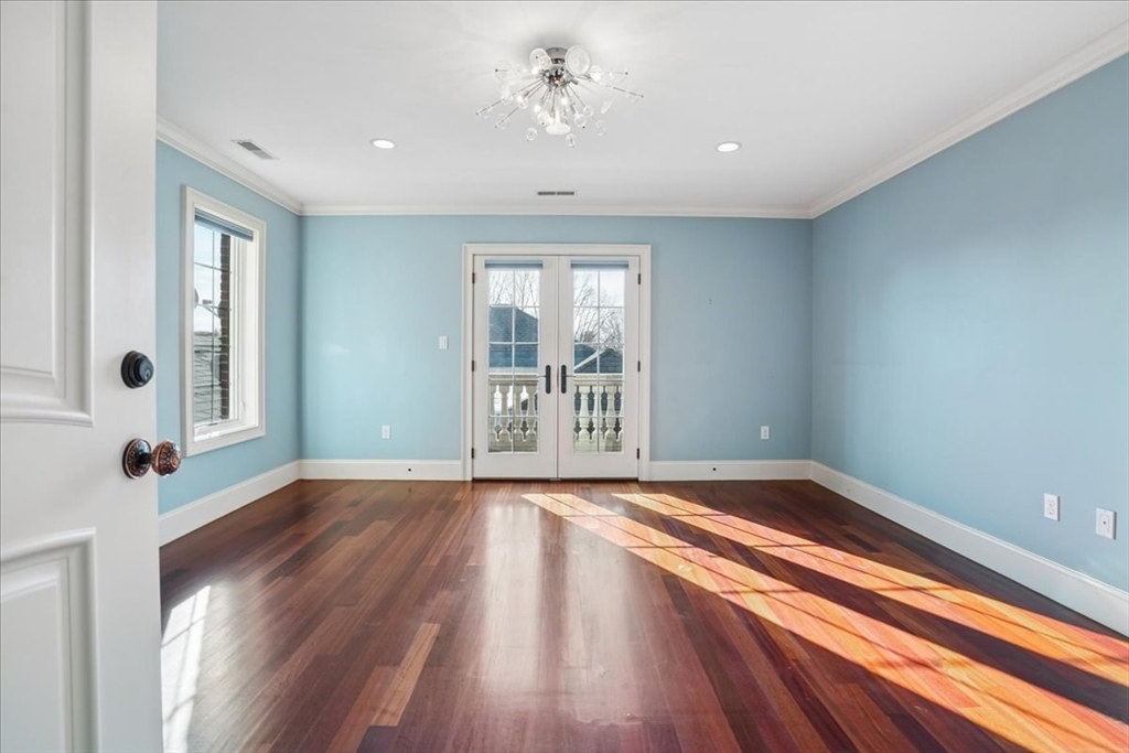 3 Regency Ridge Andover, MA 01810 - Photo 24 of 40 a view of an empty room with a window and wooden floor