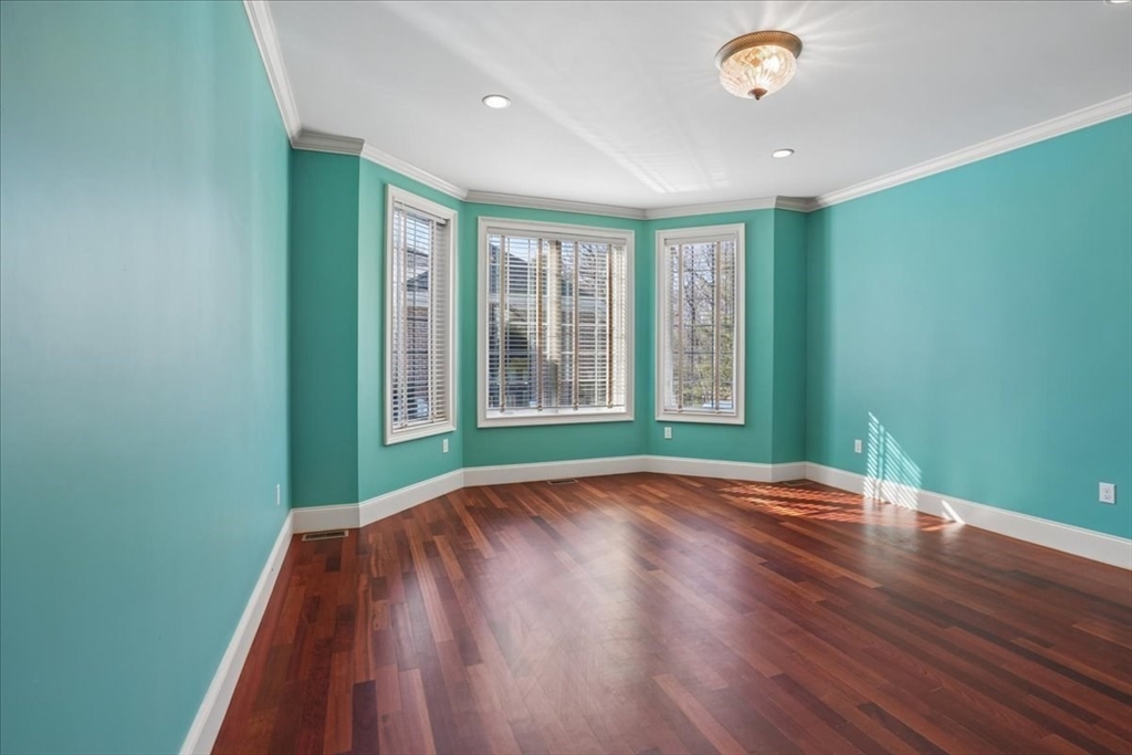 3 Regency Ridge Andover, MA 01810 - Photo 26 of 40 a view of an empty room with wooden floor and a window