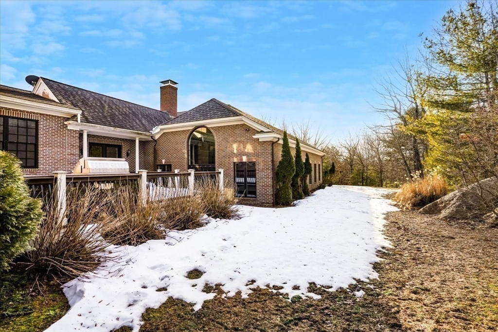 3 Regency Ridge Andover, MA 01810 - Photo 36 of 40 a front view of a house with a yard covered in snow