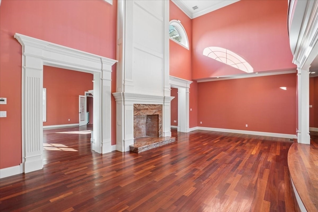 3 Regency Ridge Andover, MA 01810 - Photo 6 of 40 a view of empty room with wooden floor and fireplace