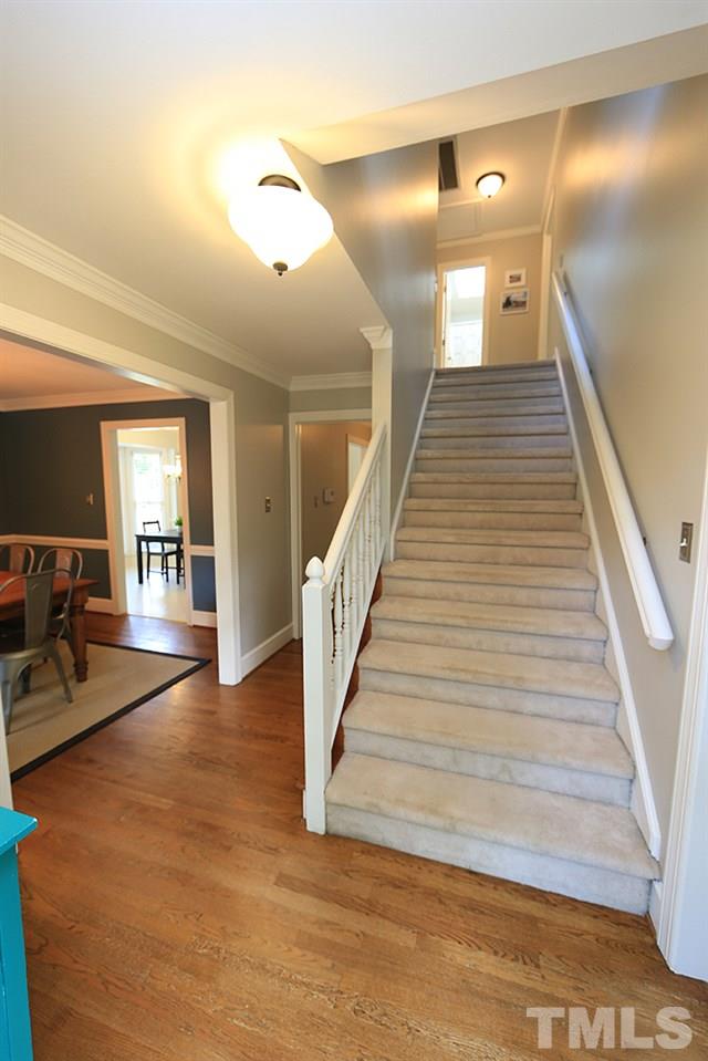 7501 Chippenham Court Raleigh, NC 27613 - Photo 3 of 29 a view of a hallway with wooden floor and stairs