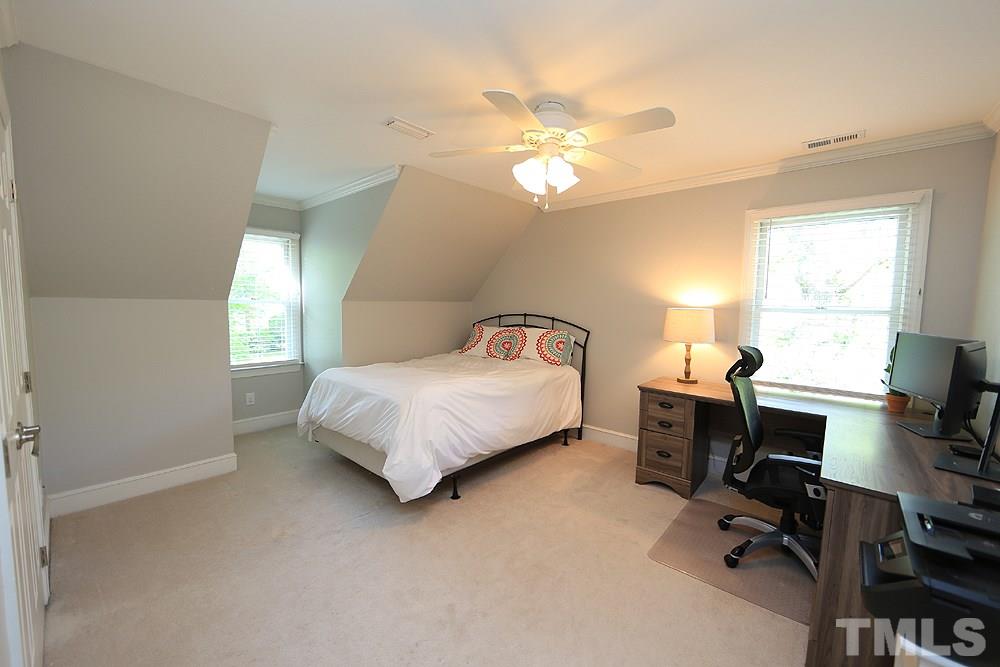 7501 Chippenham Court Raleigh, NC 27613 - Photo 22 of 29 a bedroom with a bed gym equipment and a window