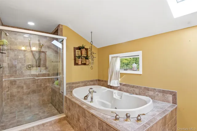 a bathroom with a tub and shower