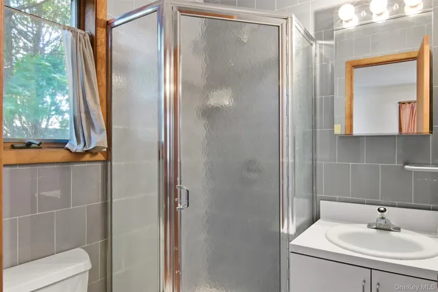 a bathroom with a sink a mirror and shower
