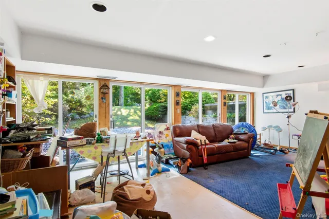 a living room with furniture and a floor to ceiling window