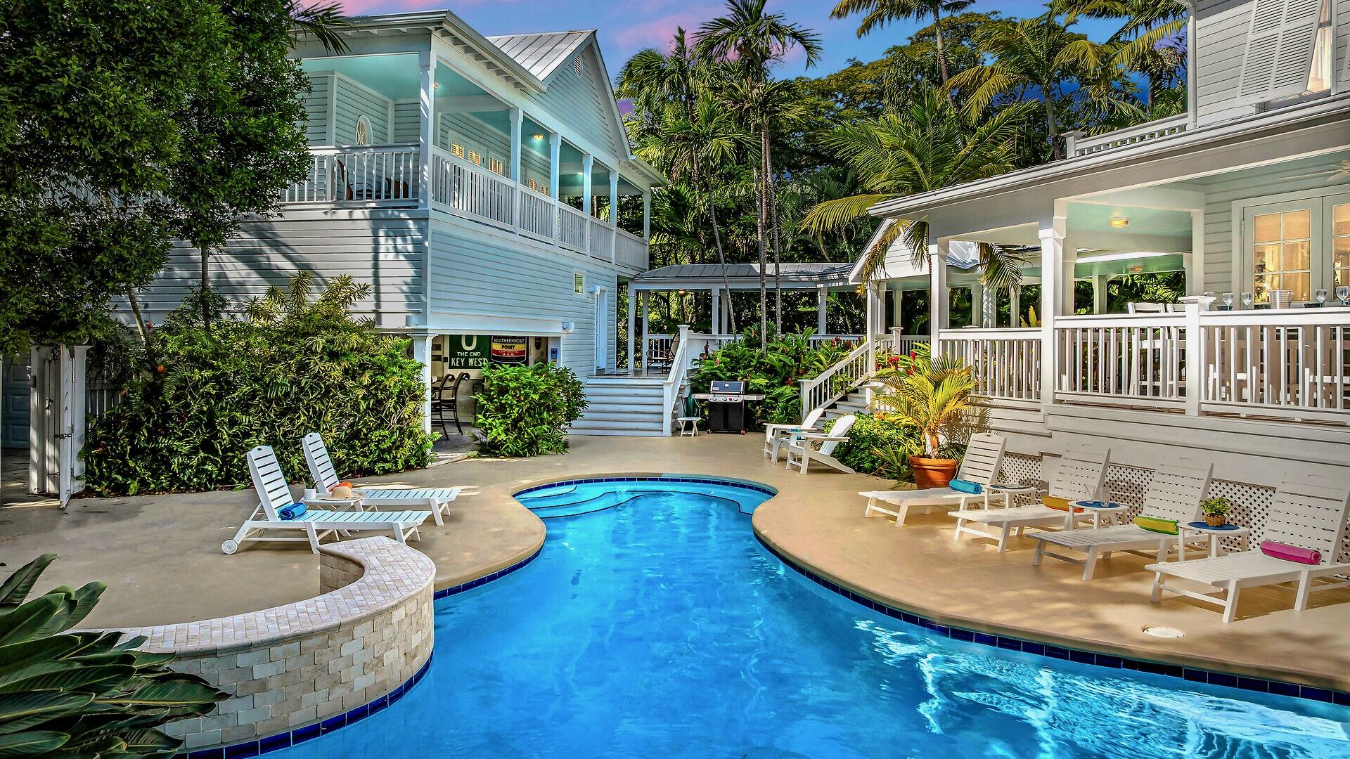 a view of a house with swimming pool and sitting area