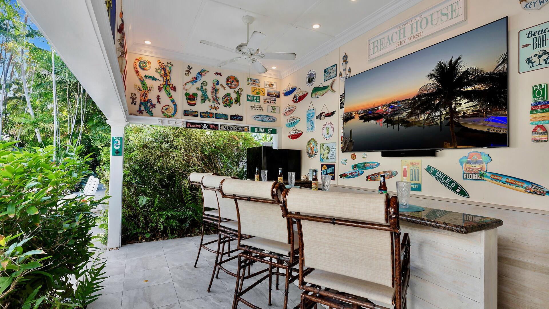 326 Caroline Street Key West, FL 33040 - Photo 14 of 47 a view of a chairs and table in a patio