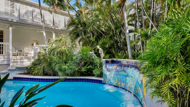 an outdoor space with pool and trees