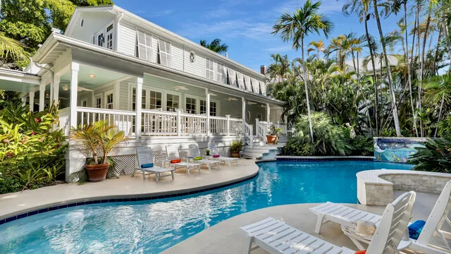 a view of house with swimming pool and sitting area