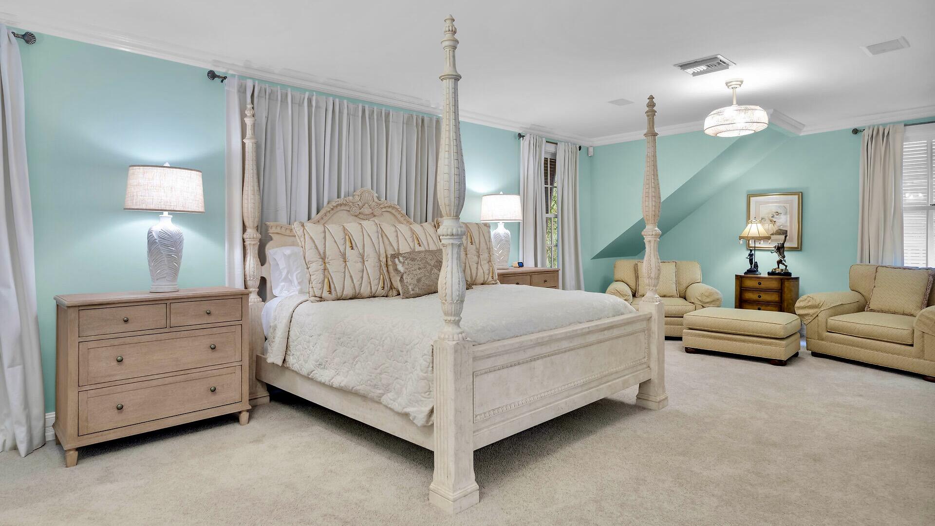 326 Caroline Street Key West, FL 33040 - Photo 21 of 47 a spacious bedroom with a bed and a chandelier