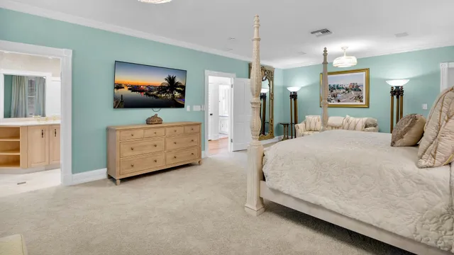 a spacious bedroom with a bed and a flat screen television