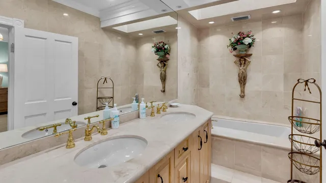a bathroom with a tub sink and mirror