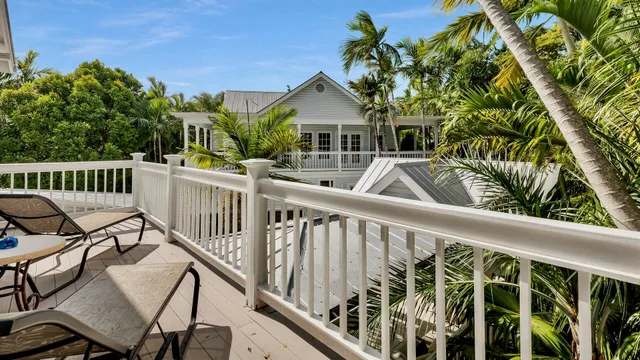 a view of house with a deck and furniture