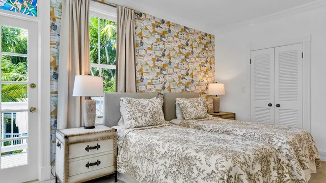 a bedroom with a large bed and a window