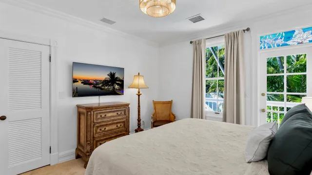 a bedroom with a bed and a flat screen tv