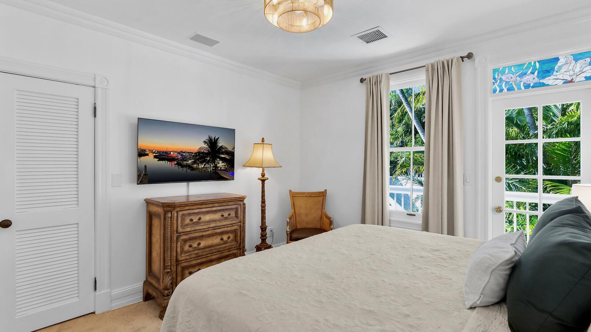 326 Caroline Street Key West, FL 33040 - Photo 30 of 47 a bedroom with a bed and a flat screen tv
