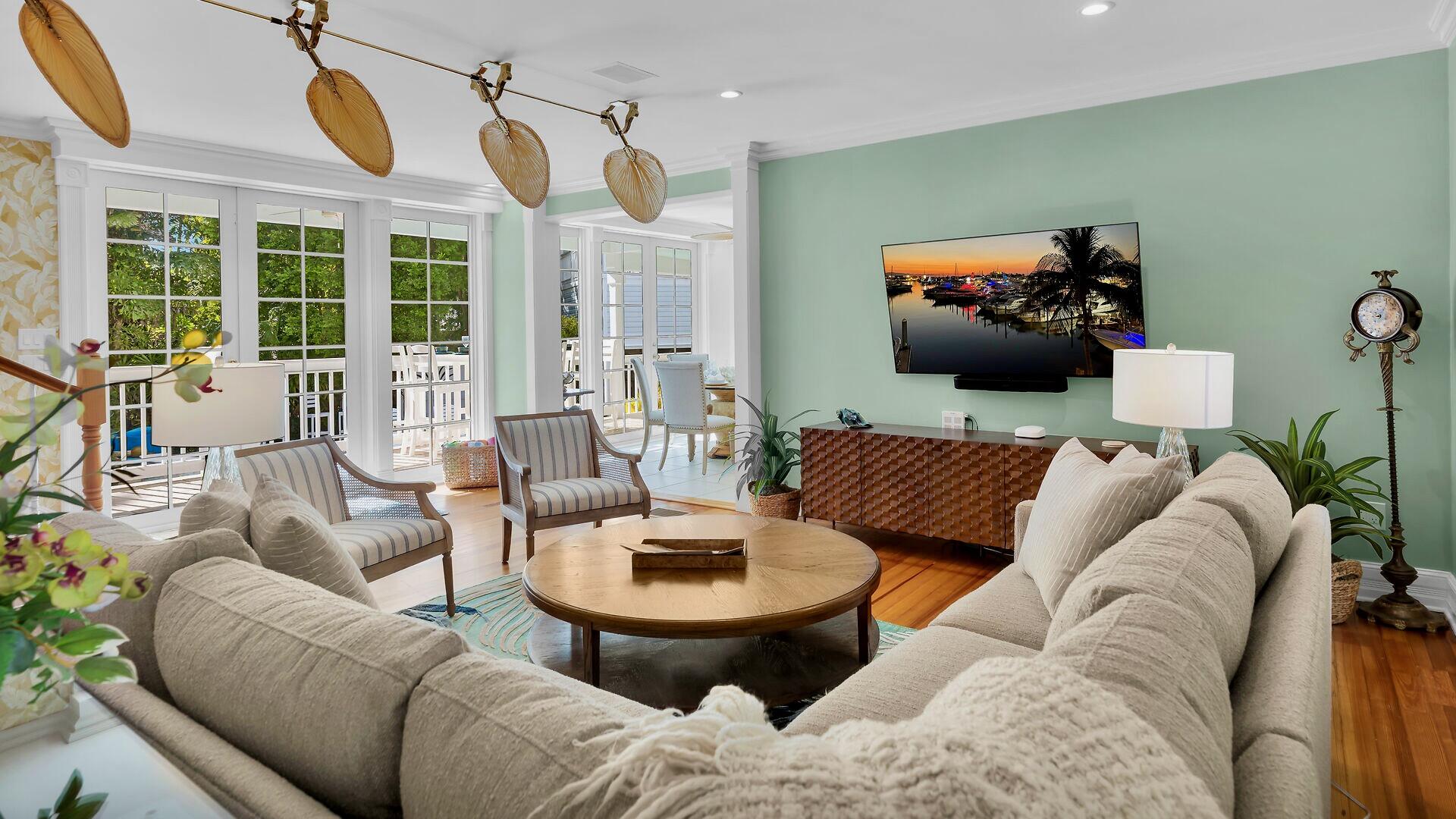 326 Caroline Street Key West, FL 33040 - Photo 3 of 47 a living room with furniture ceiling fan and a rug