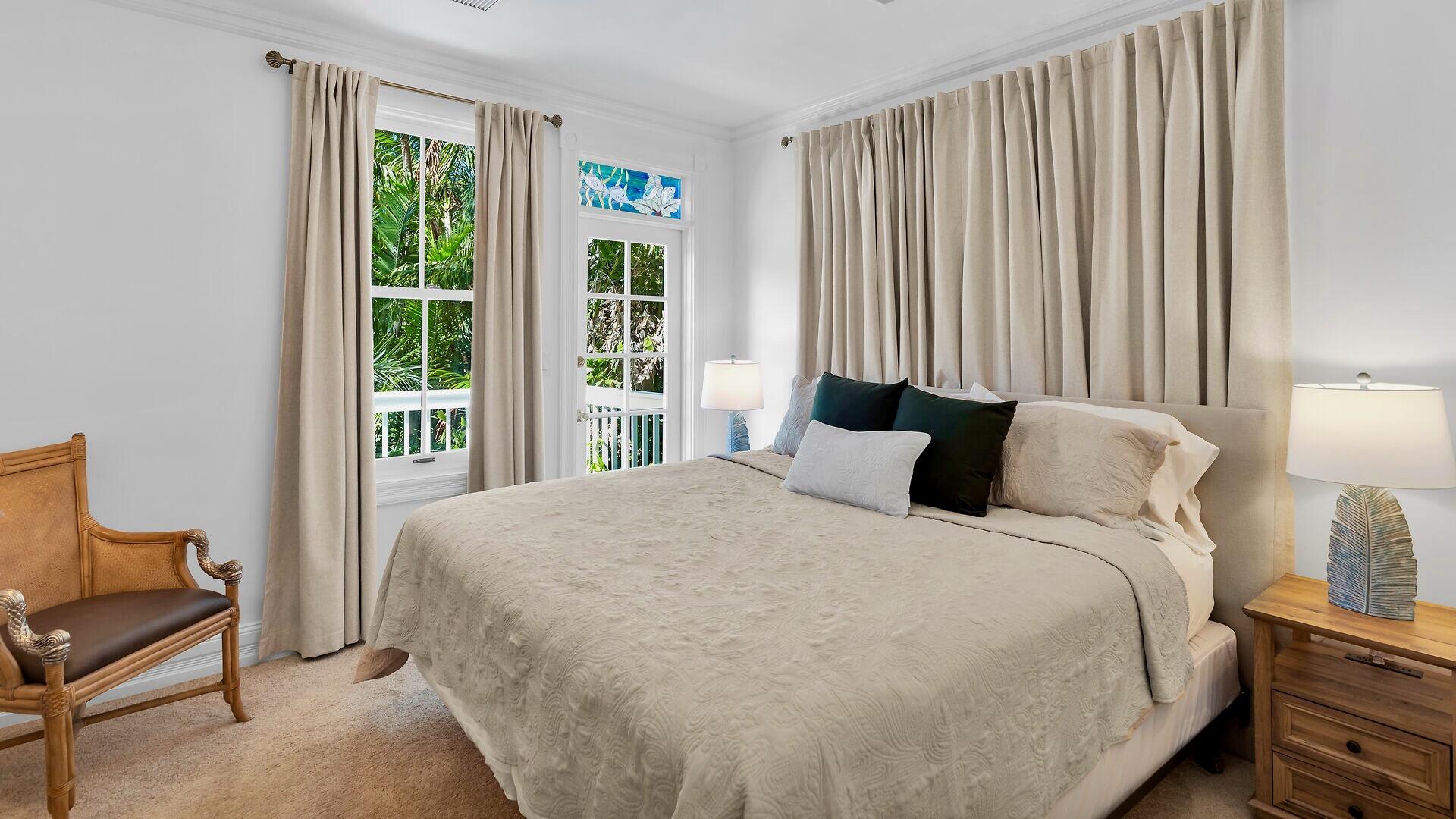 326 Caroline Street Key West, FL 33040 - Photo 31 of 47 a large bed sitting in a bedroom next to a window