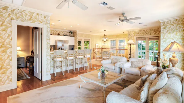 a living room with furniture and a chandelier