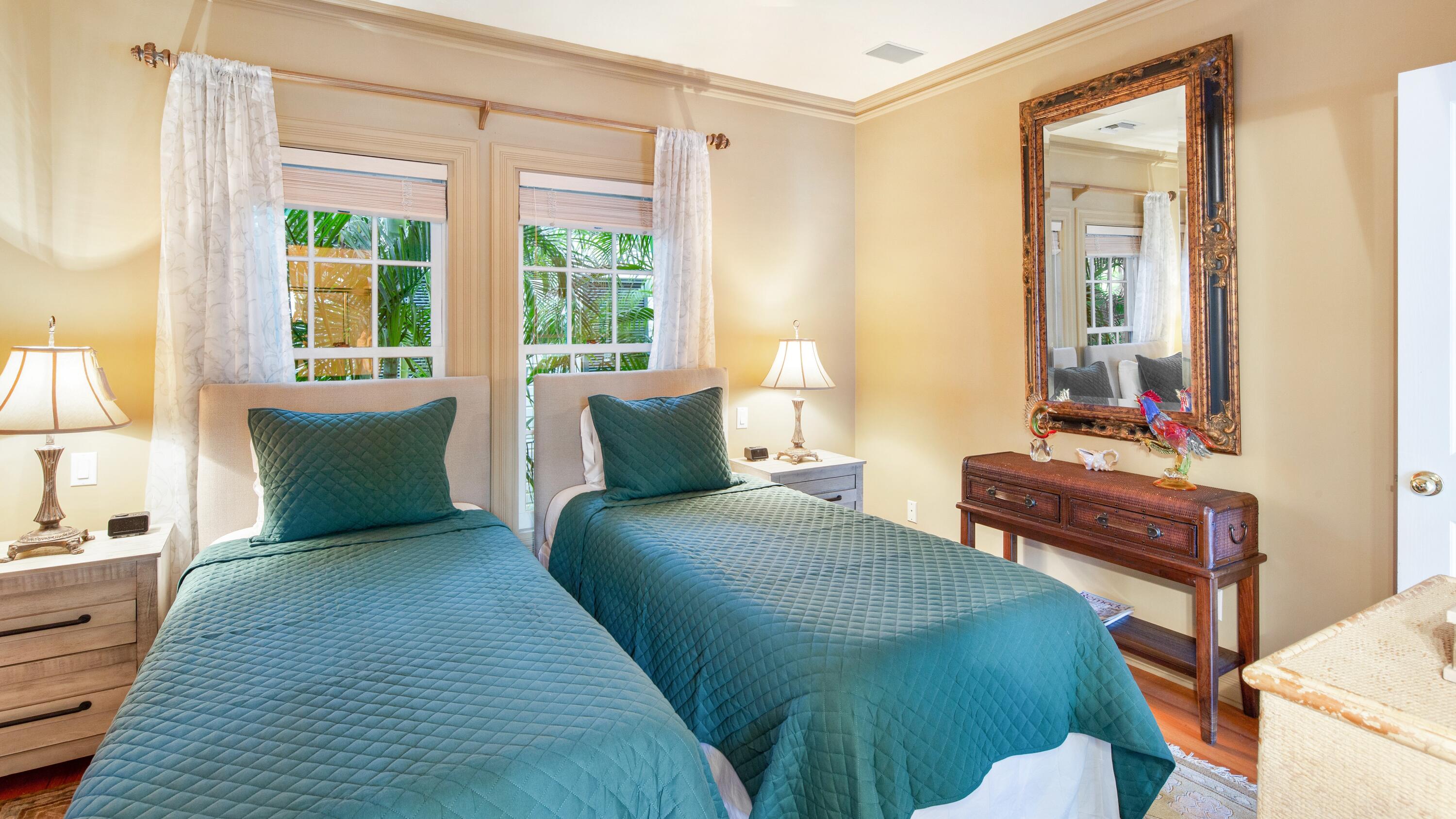 326 Caroline Street Key West, FL 33040 - Photo 39 of 47 a bedroom with a bed and wooden floor