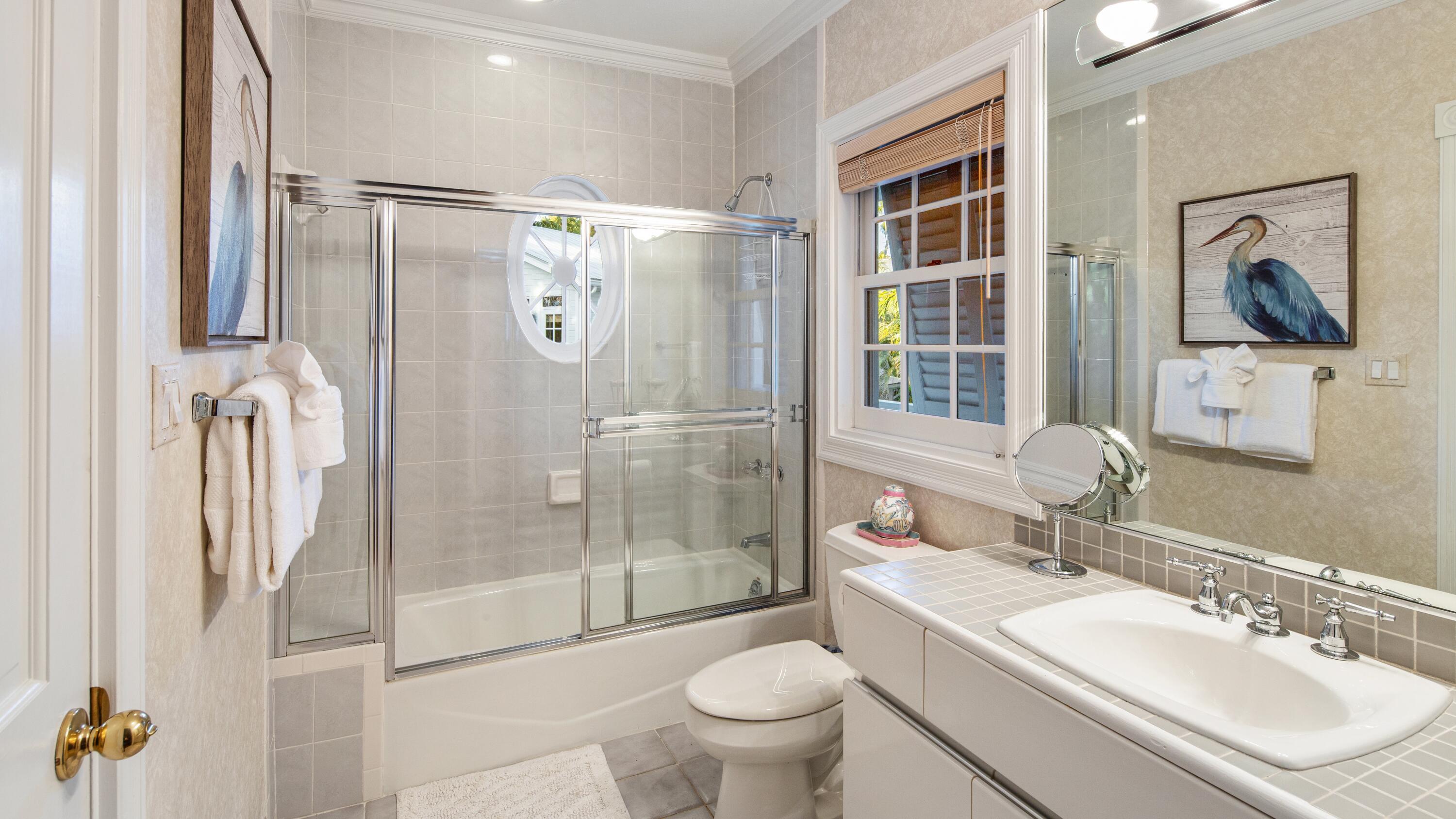 326 Caroline Street Key West, FL 33040 - Photo 41 of 47 a bathroom with a granite countertop sink toilet and shower