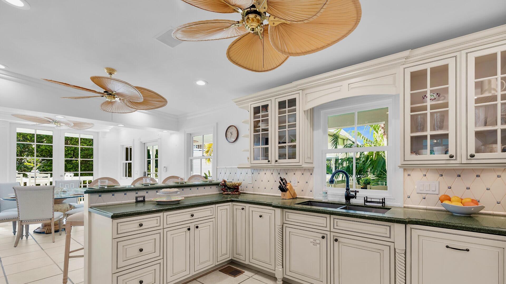 326 Caroline Street Key West, FL 33040 - Photo 9 of 47 a kitchen with sink cabinets and window