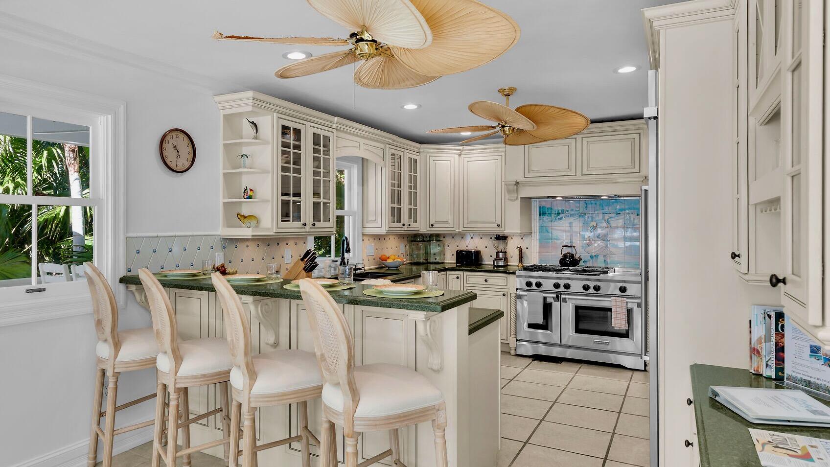 326 Caroline Street Key West, FL 33040 - Photo 10 of 47 a kitchen with stainless steel appliances granite countertop a stove and a refrigerator